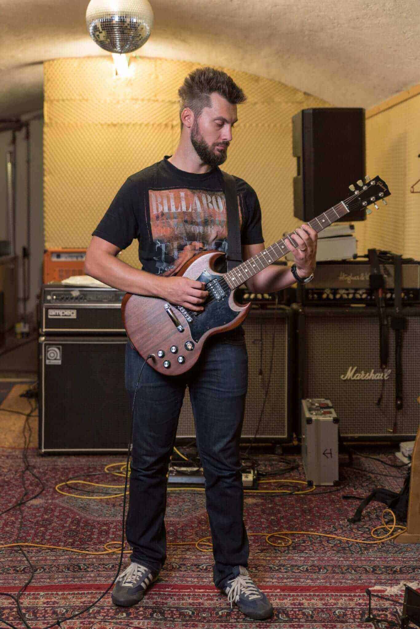 Happy Young Male Rock Musician Posing Black Electric Guitar Isolated Stock  Photo by ©AndrewLozovyi 231619116