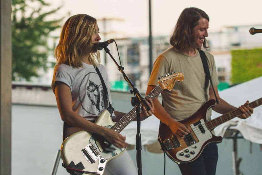 happy couple playing guitar